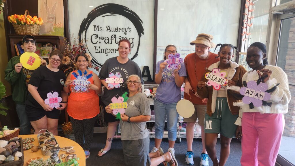 A group with special needs gathered with their finish projects and smiles!