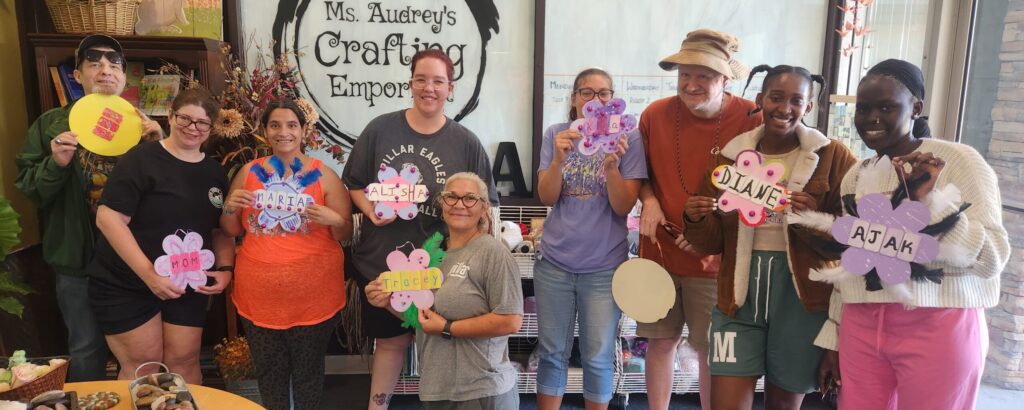 A group with special needs gathered with their finish projects and smiles!